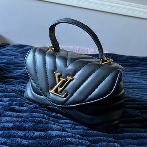 Black leather LV crossbody bag.